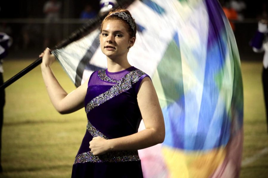 Freshman Bella Hankins performs as part of the Marching Bulldogs Color Guard.