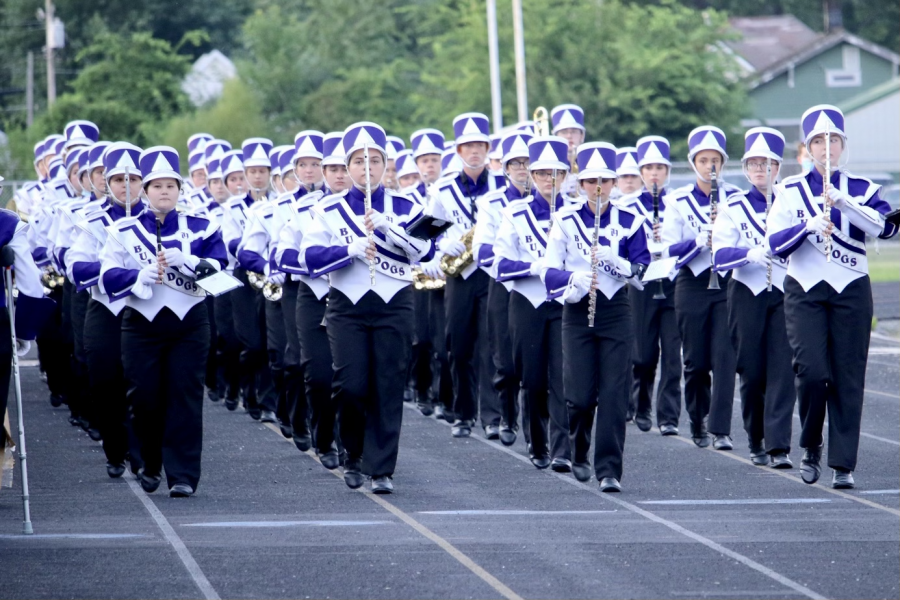 The Marching Bulldogs take the field to perform the school song and the national anthem.