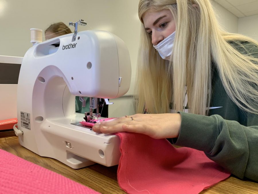 Senior Missy Chamberlain uses the sewing machine. 