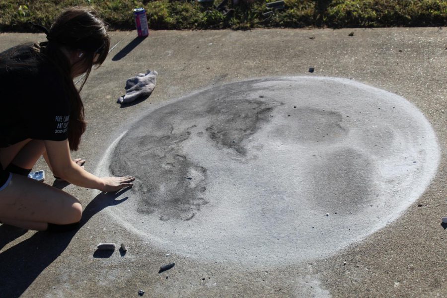 Unknown student works on her drawing of the moon.