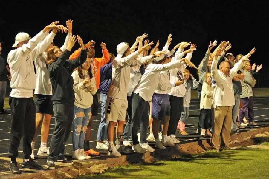 Principal Scott Dewar leads the fans in Big Dogs, Little Dogs. 