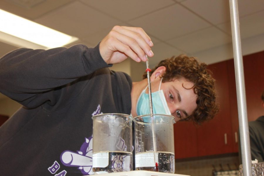 Freshman Reed Rider tests the waters with his thermometer.
