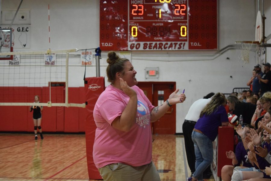Assistant coach Taryn Dewar leads the Ladydogs in a cheer while refs have a long discussion Sept. 14