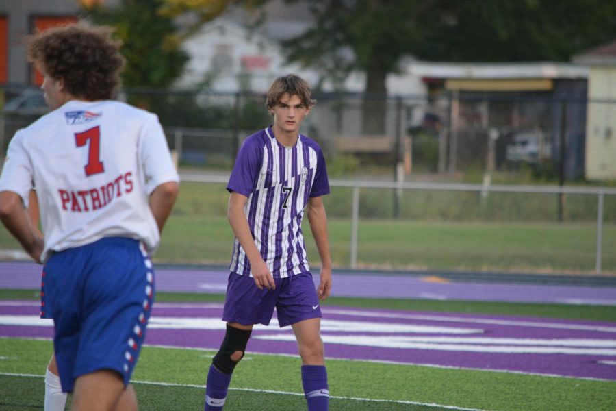 Senior Sebastion Brown walks across the field.