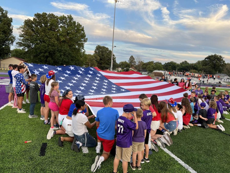 Dog Pound holds the large flag during the National Anthem. 