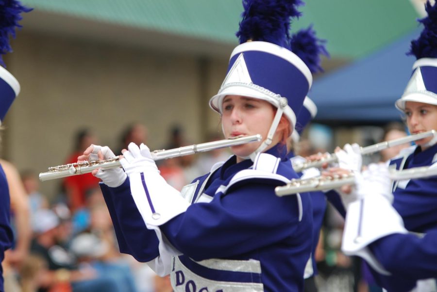 Junior Eliza Markum plays the flute during the Popcorn Days parade.
