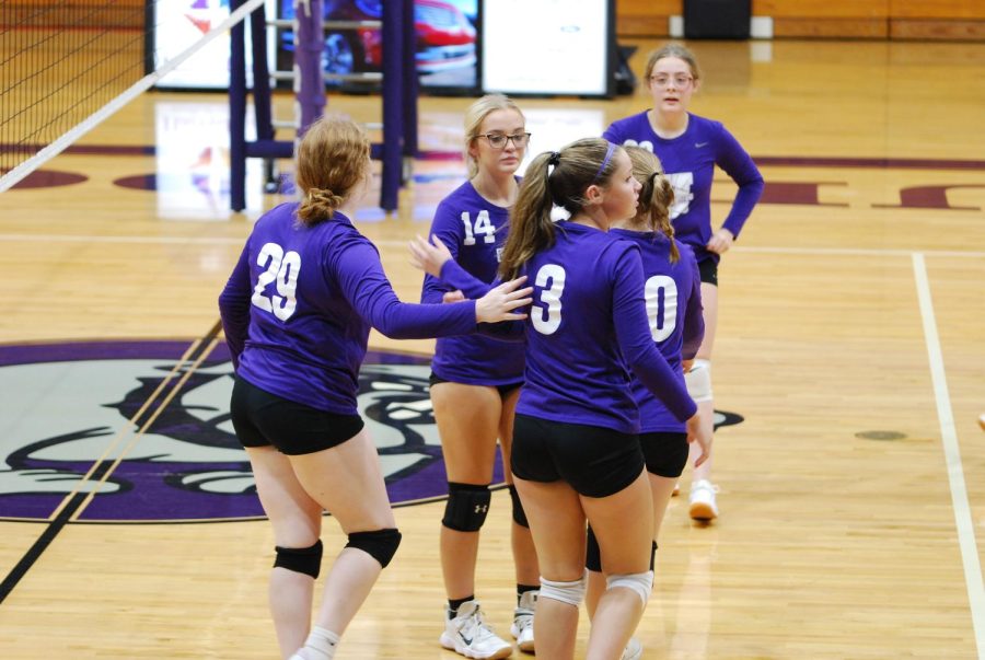 Juniors Layla Borders and Maysa Moore and sophomores Kaylee King, Emma Miles, and Taylor Michel congratulate one another after making the point.