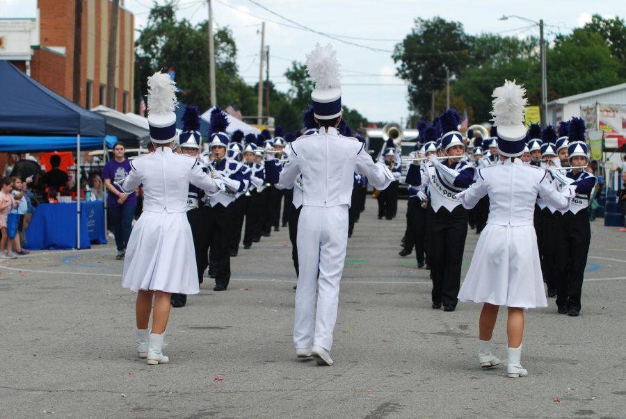 Drum Majors senior Braxton Baugher, junior Mary Beth Winkleman, and junior Ali Hankins leading the hhs marching band.
 