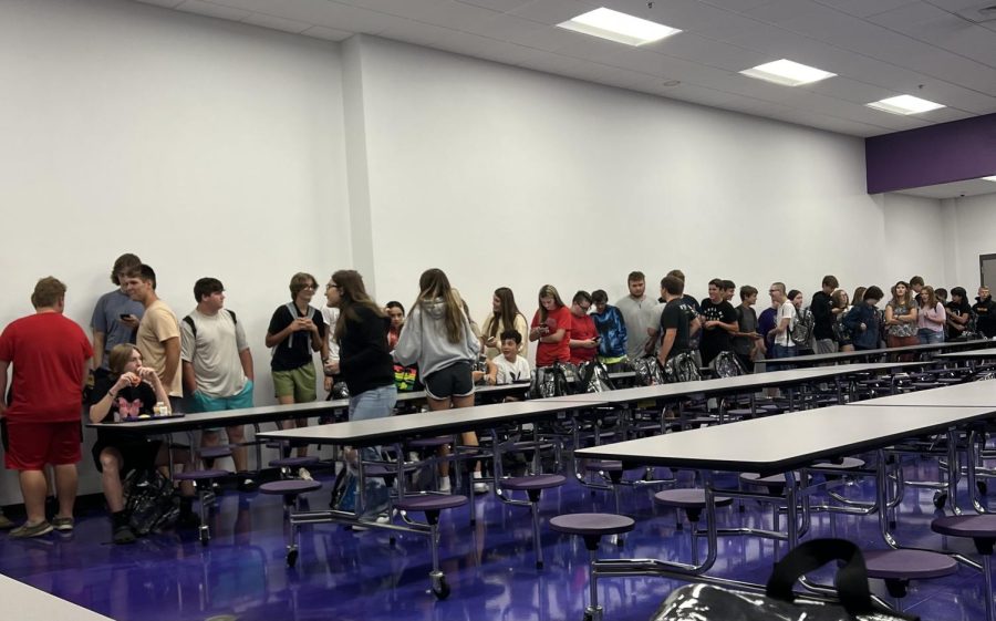 Students stand in line during lunch waiting to get their food.