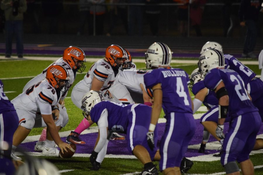 The+defensive+line+gets+in+position+for+the+next+play+against+the+Carterville+Lions.+The+Bulldogs+lost+the+game+but+maintained+their+playoff+hopes.