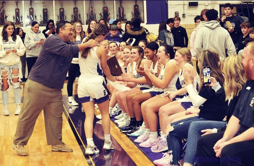 Senior Sidney Neal receives congratulations. from her team on honors received at the preview tourney 