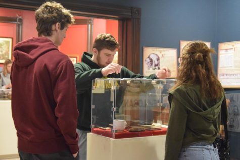 Juniors Jacob Mitchell, Jaxon Quisenberry and Mackenzie Partain examine artifacts at the John A. Logan museum. They took notes about things at the museum and recorded which artifacts were their favorites