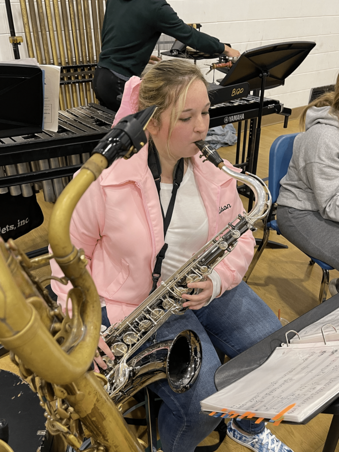Senior+Allison+Dennison+practices+the+tenor+saxophone+at+an+orchestra+rehearsal+at+Downers+Grove+South+High+School+Oct.+9+2022.