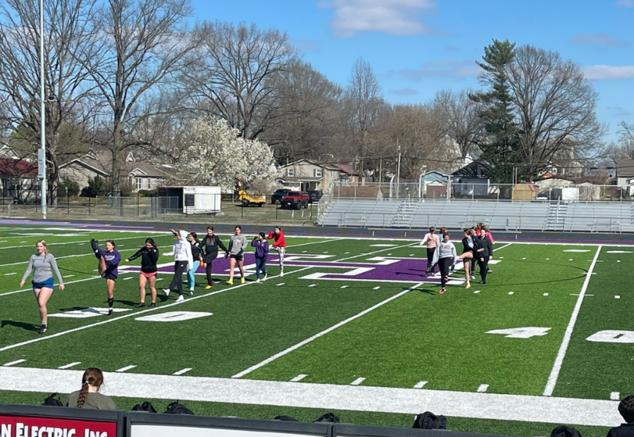 The girls soccer team goes through warm-up drills before beginning practice. 