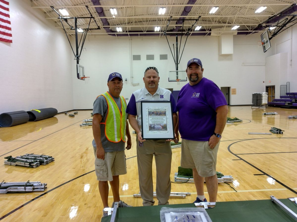 Principal Scott Dewar was presented with a certificate of appreciation from the Gold Star Mission Riders prior to their departure Sept. 22. The group spend the night in the auxiliary gym. Members of several clubs and school organizations worked to welcome the group and make them comfortable during their stay. 