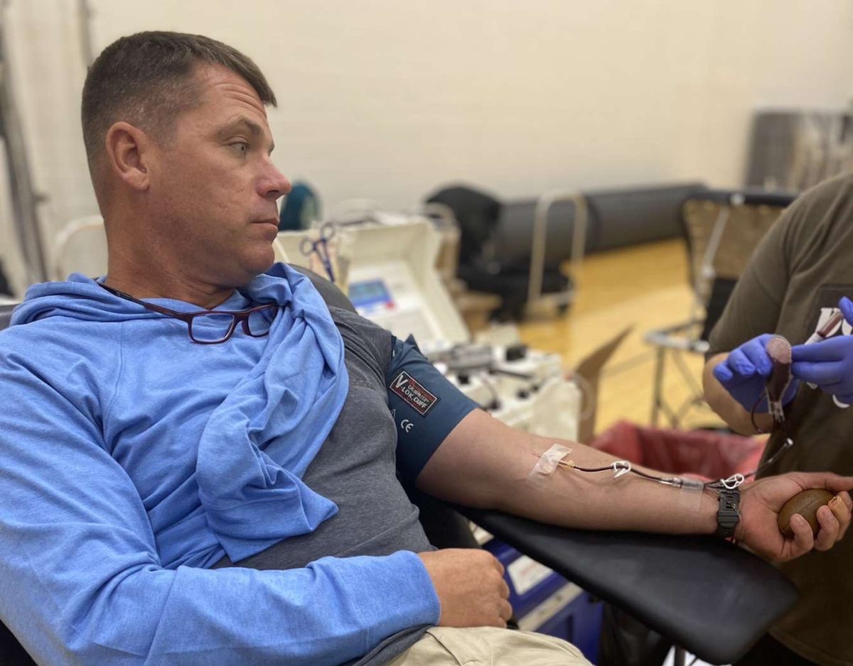 PE teacher Josh Allen patiently waits during his blood donation. 