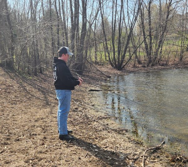 Aaron Gulley enjoys a relaxing afternoon while fishing. Gulley learned to fish when he was four years old, and has taken up the hobby more recently in the past year. 