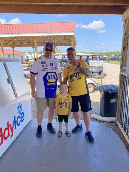 West Side Primary principal Scott Dewar poses with his family at a NASCAR Race. Dewar has enjoyed NASCAR for many years, since watching the first televised Daytona 500. The races are always fan-friendly, Dewar said.
