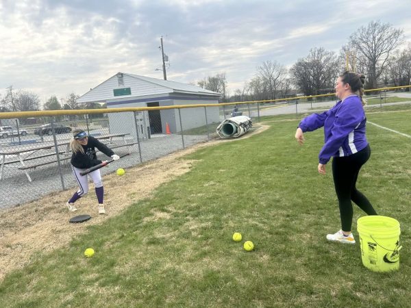 Senior Mckenzie Boyd practices bunting with Emily Scott in preparation for their upcoming game.