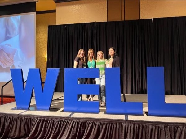 Seniors Regen Arnett, Tessa Harrison, Khoal Goodson and Superintendent Dr. Amy Dixon attend the Well Summit conference in Bloomington March 15th.