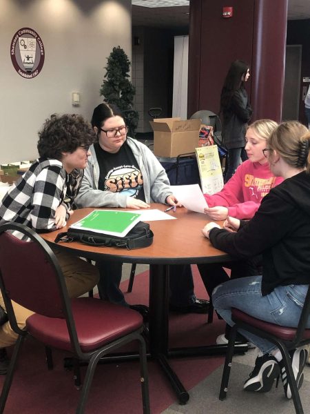 Seniors Kylan Jerrell, Khoal Goodson, Tessa Harrison and Regen Arnett convene at the Future Educators Club field trip March 25. The group brainstormed to write a persuasive essay about AI in the classroom. The group placed second in the challenge. 