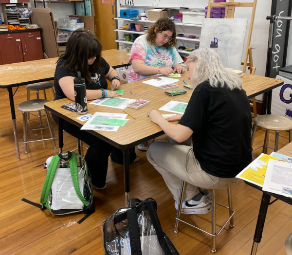 Seniors Francesca Messerschmidt, Kimberly Riley and junior Dex Randolph work on their pieces of a collaborative project. Students in Drawing and Painting created two collaborative art works in total. The artworks created were interpretations of Van Goghs Sunflowers and Irises.