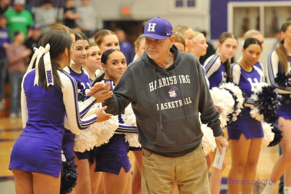 HHS staff member Steve Vinyard receives a check from the cheerleading squad during a basketball halftime ceremony last year.