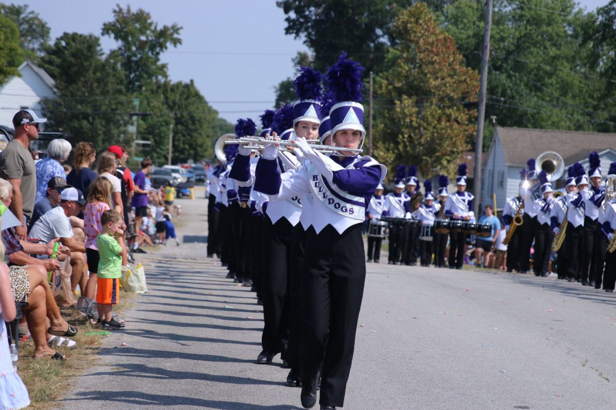 Junior Crissa Moore leads her line down the street at the Popcorn Days Parade in Ridgway, Illinois.
