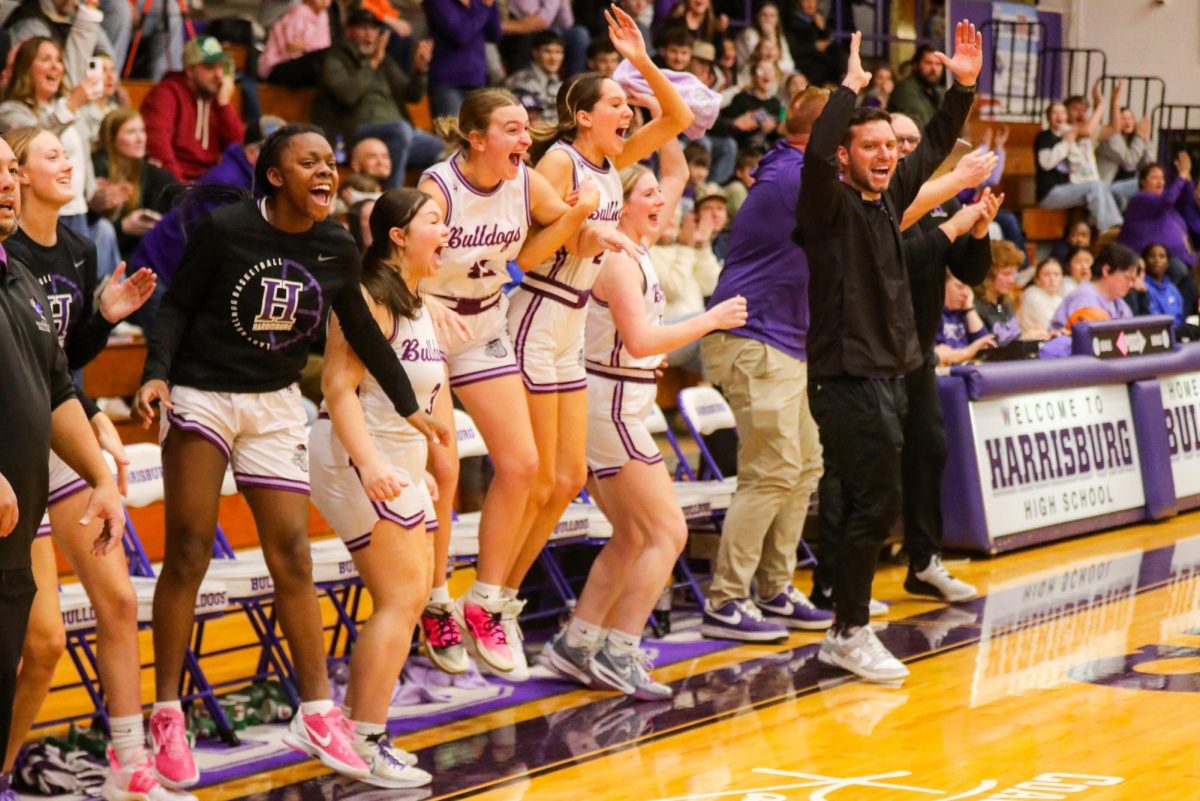 The Lady Bulldogs jump in celebration as Green scores the record breaking point.